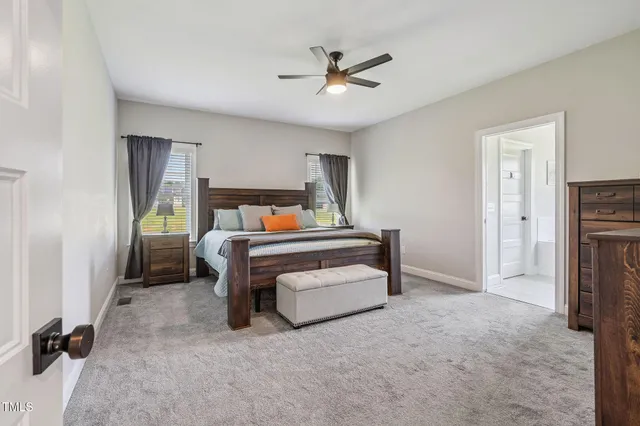 a bedroom with a bed and a ceiling fan
