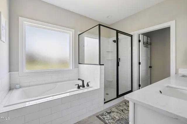 a bathroom with a bathtub and a shower