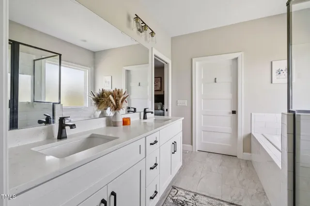 a bathroom with a double vanity sink mirror and double