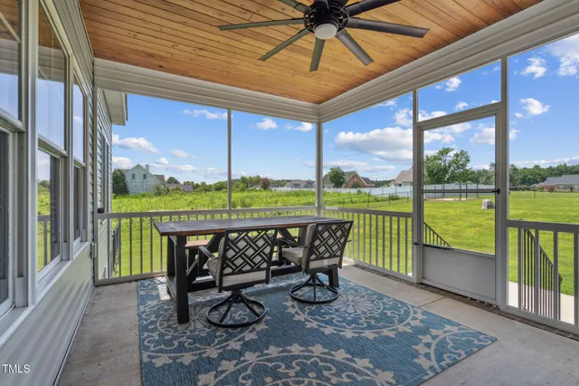 a view of swimming pool with a table and chairs under an umbrella