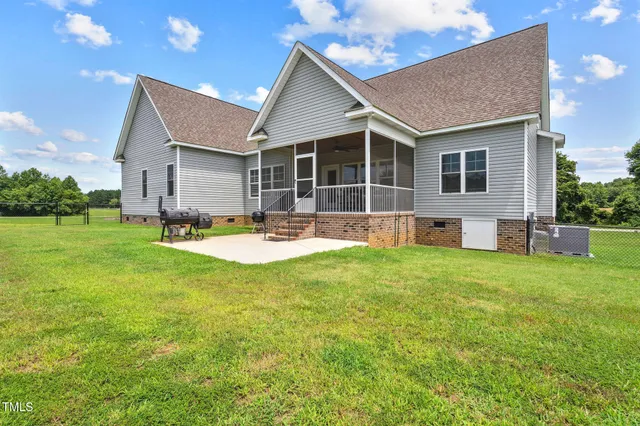 a front view of house with a garden and patio