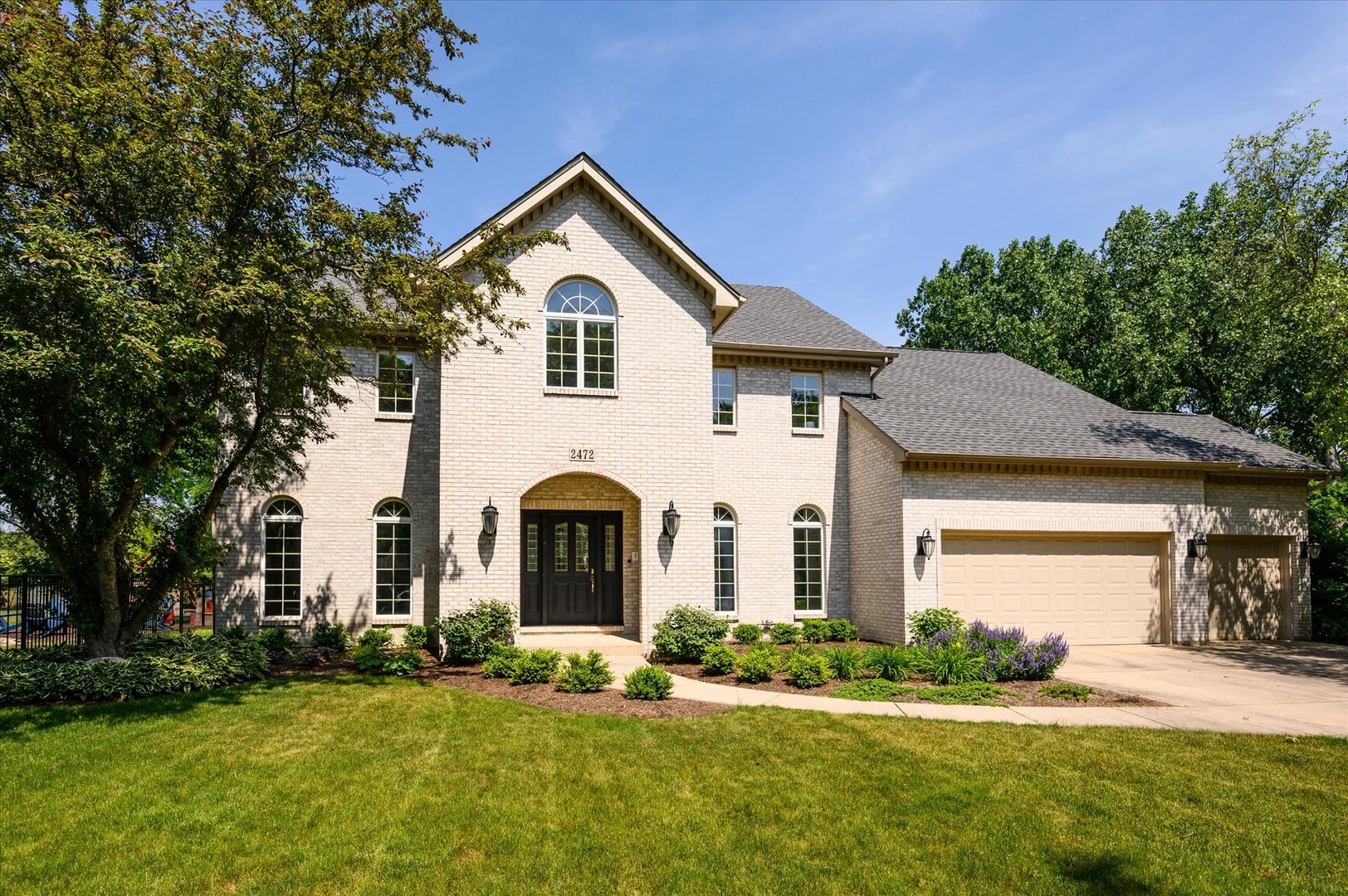 a front view of a house with a yard and garage