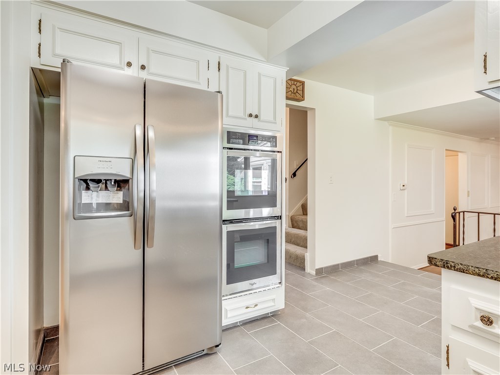 1047 Roland Road Lyndhurst, OH 44124 - Photo 5 of 26 The Eat-In Kitchen is located down the hall way. It features refinished cabinets, brand-new stainless steel appliances, granite countertop, new sink and faucet, new ceramic tile flooring, and new light fixtures.