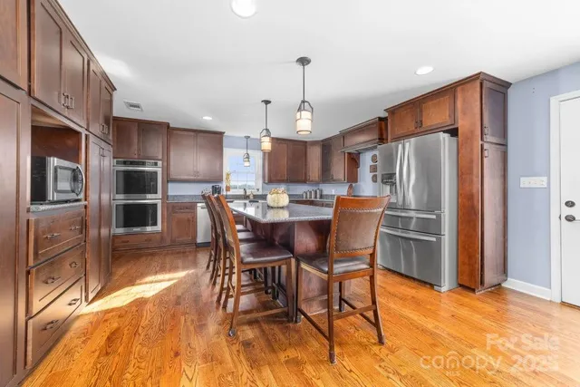 a living room with furniture a dining table and a stove top oven