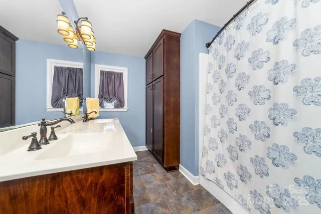 a bedroom with a bed and windows