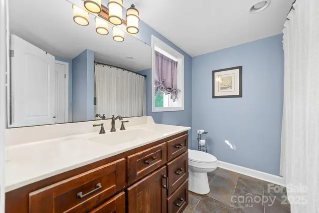 a bedroom with a bed dresser and a potted plant