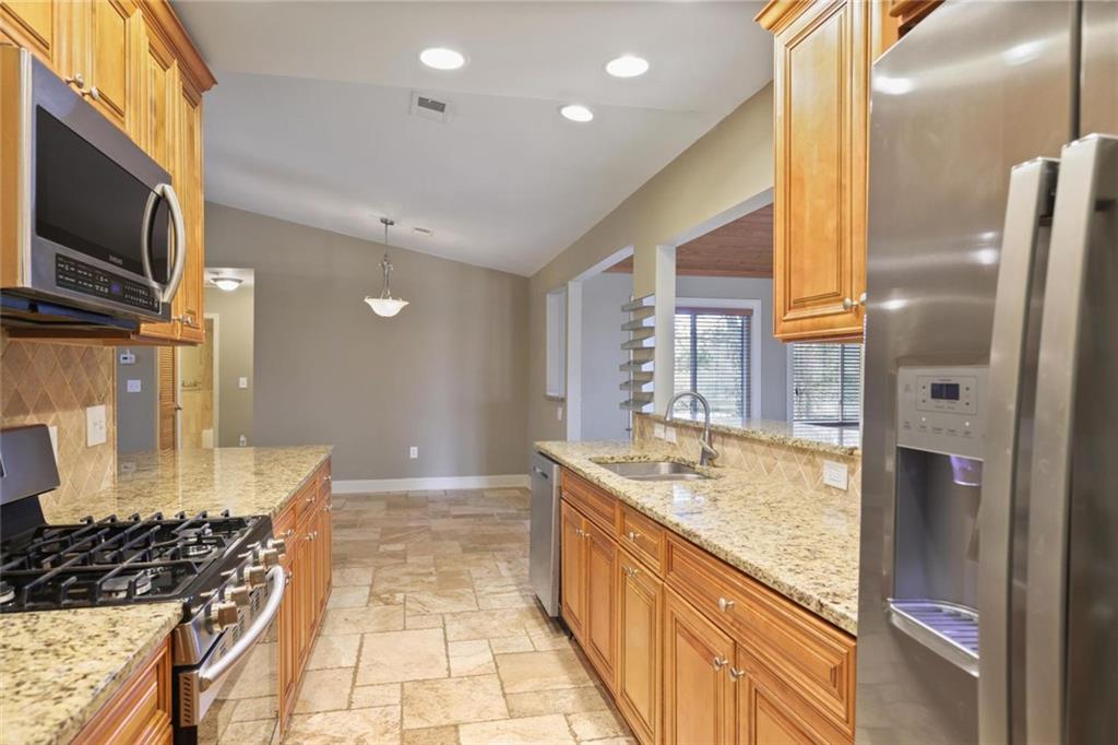 3851 Trickum Road Marietta, GA 30066 - Photo 12 of 27 a spacious bathroom with a granite countertop tub sink and mirror