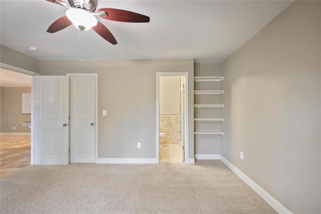 3851 Trickum Road Marietta, GA 30066 - Photo 18 of 27 a view of an empty room with a ceiling fan
