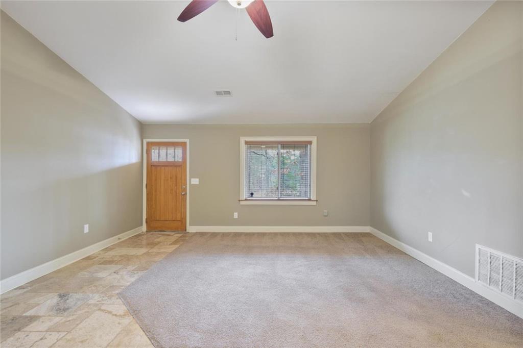 3851 Trickum Road Marietta, GA 30066 - Photo 4 of 27 a view of an empty room with chandelier fan and windows