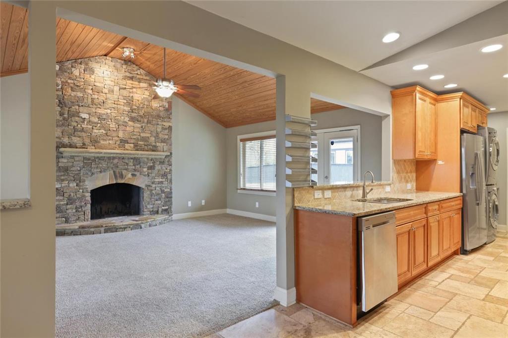 3851 Trickum Road Marietta, GA 30066 - Photo 7 of 27 a view of a kitchen with stainless steel appliances granite countertop a stove and cabinets