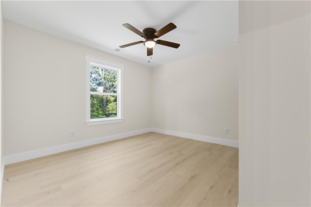 5818 Eastside Drive Austell, GA 30168 - Photo 11 of 39 an empty room with ceiling fan and window