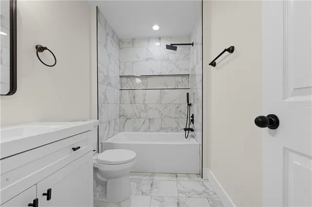 a bathroom with a toilet bathtub and shower
