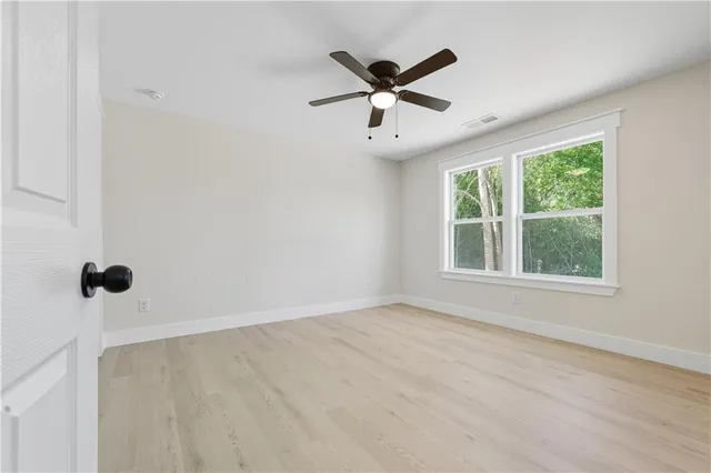 wooden floor in an empty room with a window