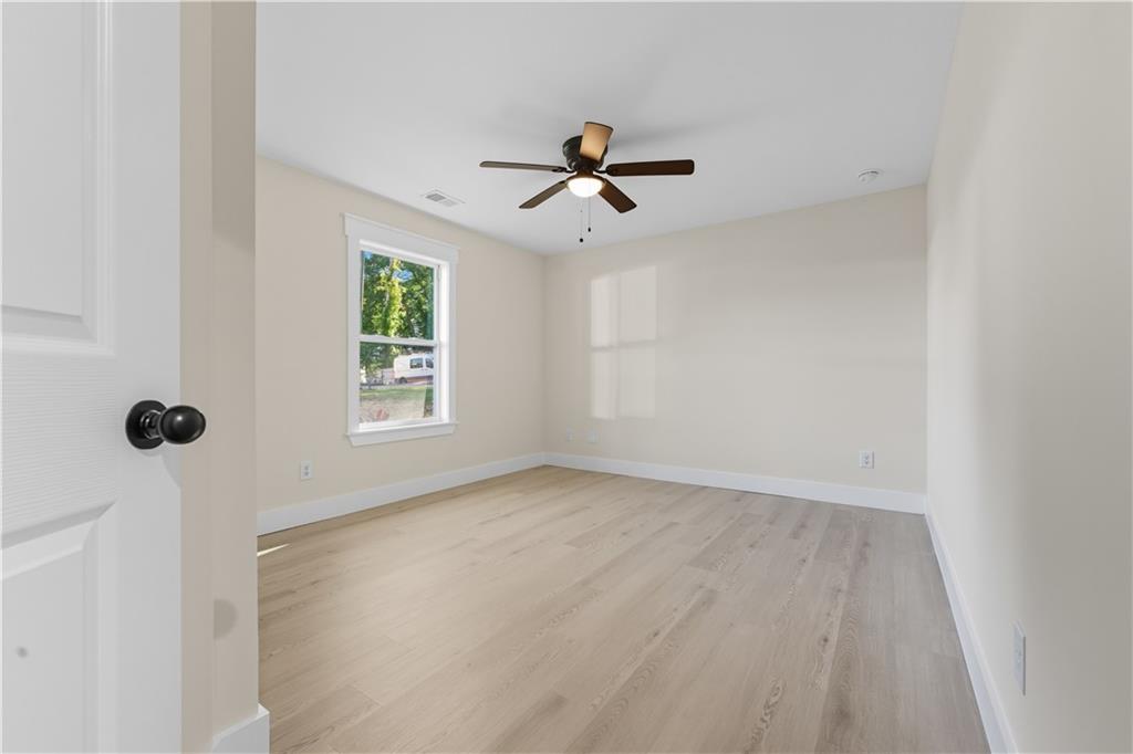 5818 Eastside Drive Austell, GA 30168 - Photo 20 of 39 an empty room with windows and fan