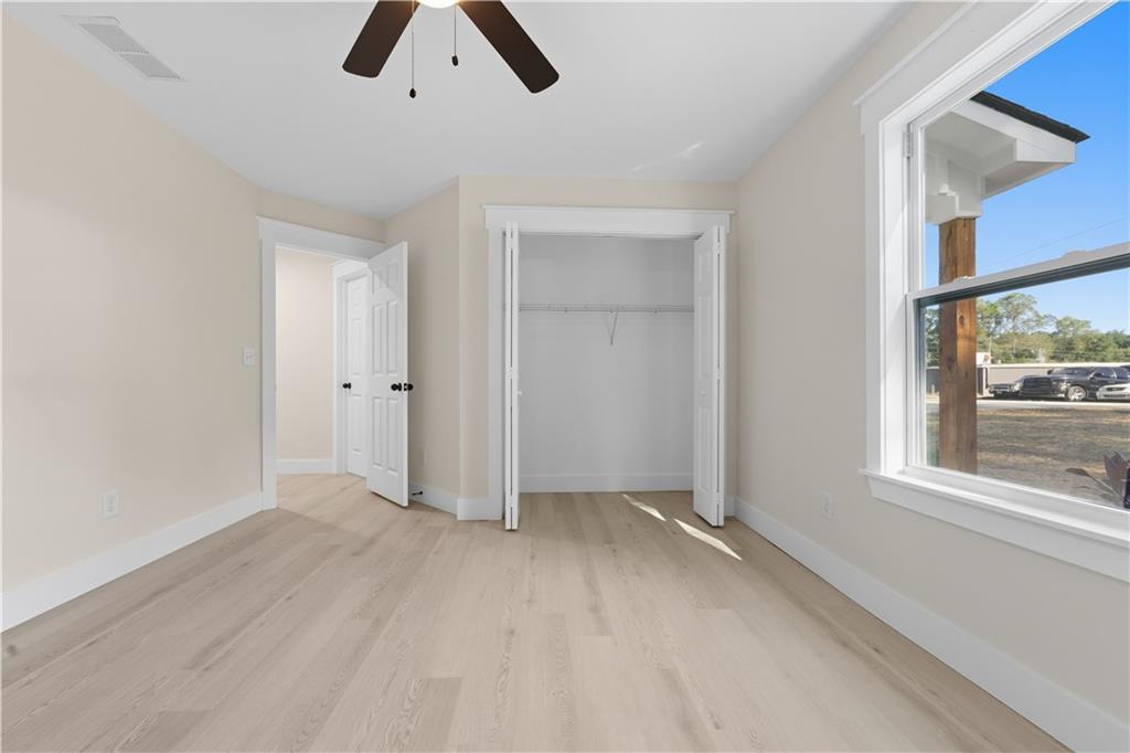 5818 Eastside Drive Austell, GA 30168 - Photo 21 of 39 an empty room with chandelier fan and windows