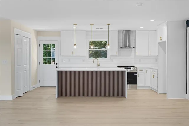 a kitchen with a sink cabinets and window