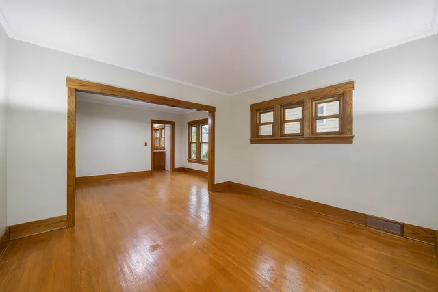 a view of a workspace with furniture window and wooden floor
