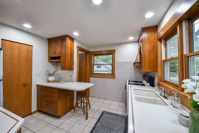 a kitchen with kitchen island a sink stove and refrigerator