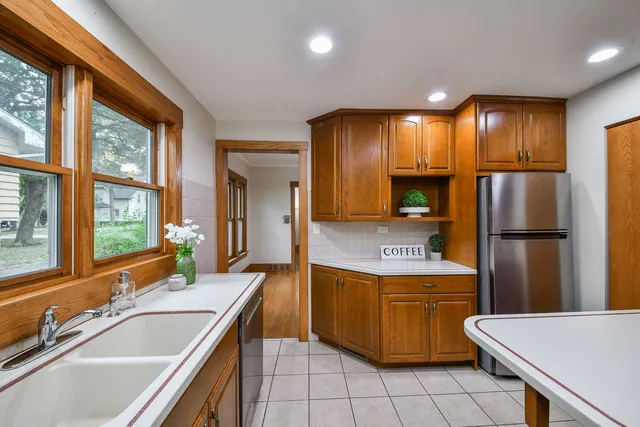 a kitchen with stainless steel appliances granite countertop a stove a sink and a microwave