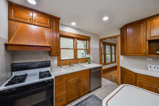a bathroom with a sink a toilet a mirror and shower curtain