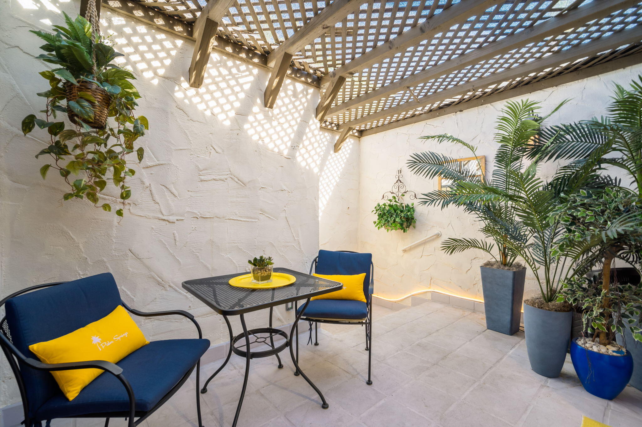 1757 Ramon Road, Unit 40 Palm Springs, CA 92264 - Photo 8 of 20 a view of a chairs and table in a backyard