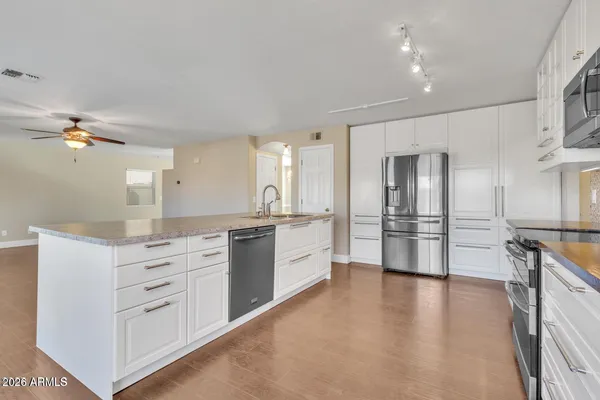 a large kitchen with cabinets and stainless steel appliances