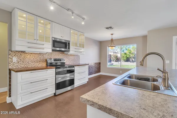 a kitchen with granite countertop a stove and a sink