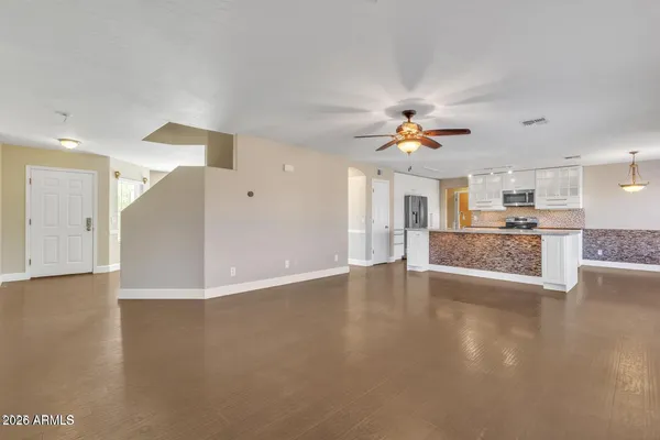 a view of a kitchen with a sink and a chandelier fan