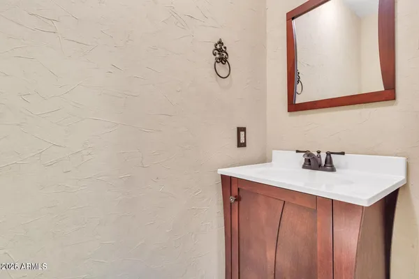 a bathroom with a sink vanity and a mirror