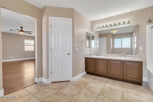 a spacious bathroom with a mirror sink and cabinets