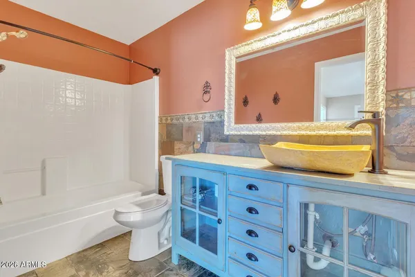 a bathroom with a sink a toilet and bathtub