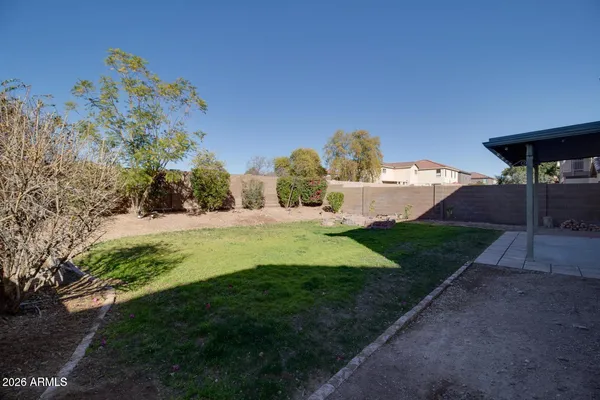 a backyard of a house with yard and outdoor seating