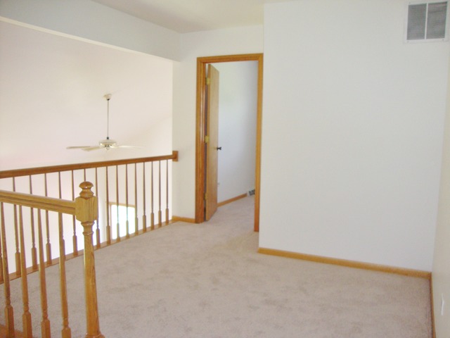19201 Weber Road Mokena, IL 60448 - Photo 12 of 15 a view of a hallway with wooden floor and entryway