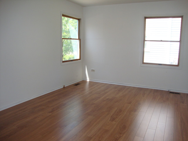 19201 Weber Road Mokena, IL 60448 - Photo 8 of 15 an empty room with wooden floor and windows