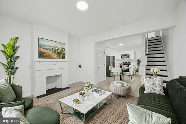 a living room with furniture and a fireplace