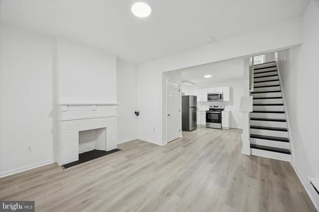 a view of kitchen and hall with wooden floor