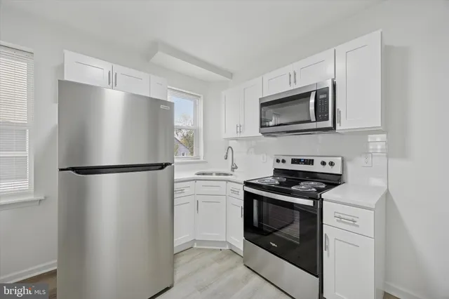a kitchen with a refrigerator stove and microwave
