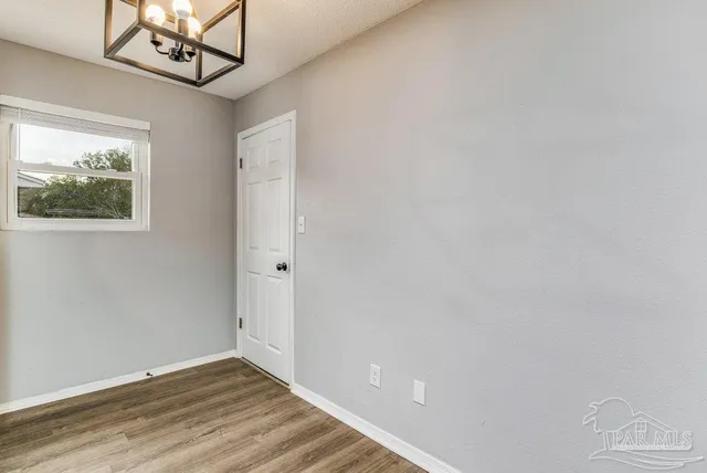 a view of an entryway with wooden floor