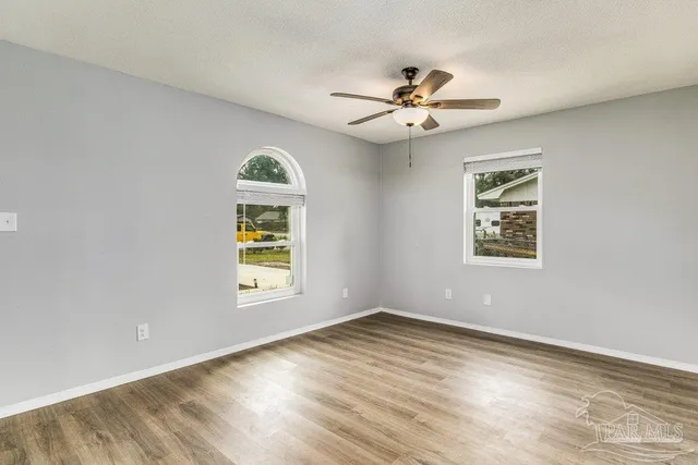 wooden floor in an empty room with a window