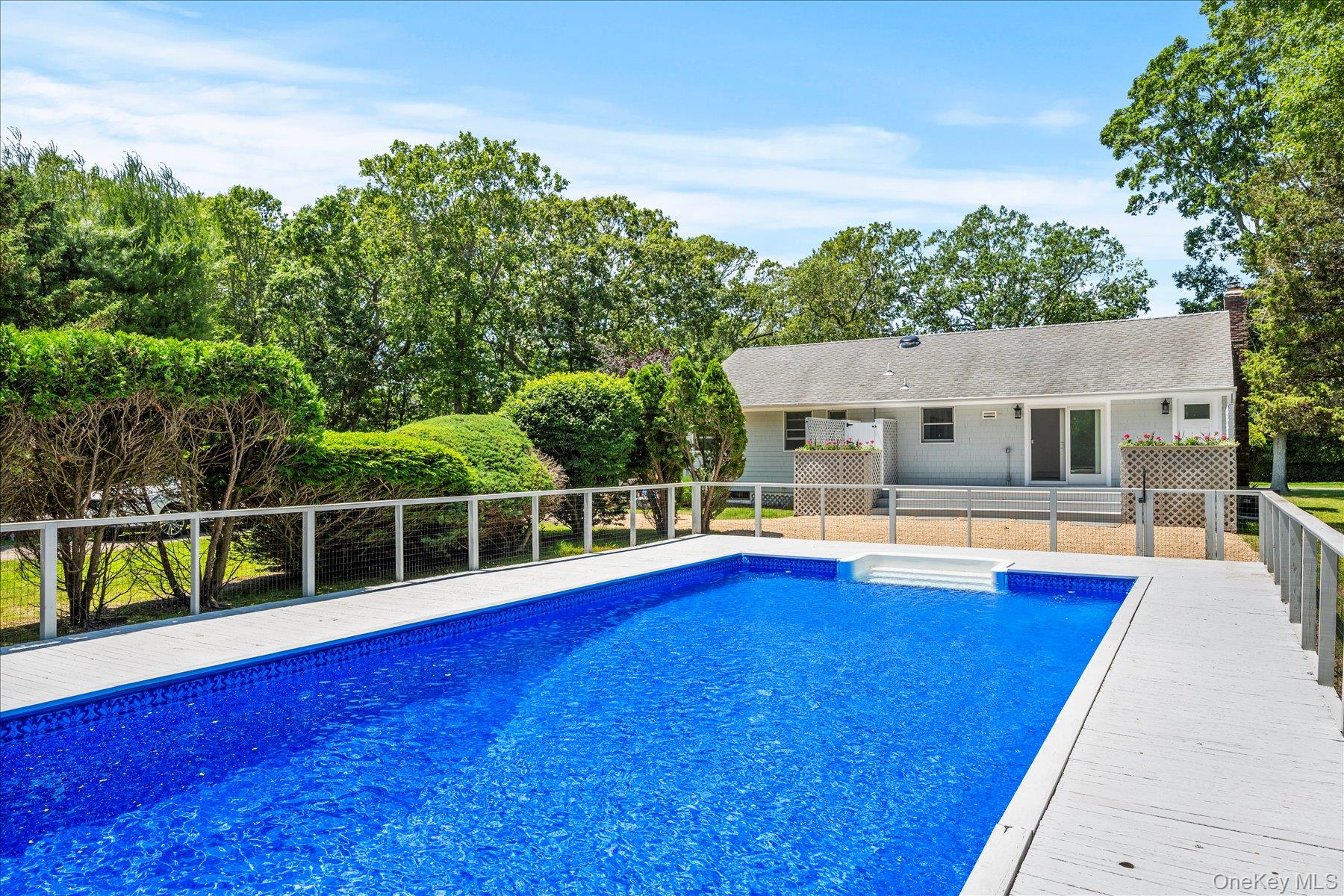 64 Old Depot Road Quogue, NY 11959 - Photo 13 of 14 a view of a house with swimming pool and porch