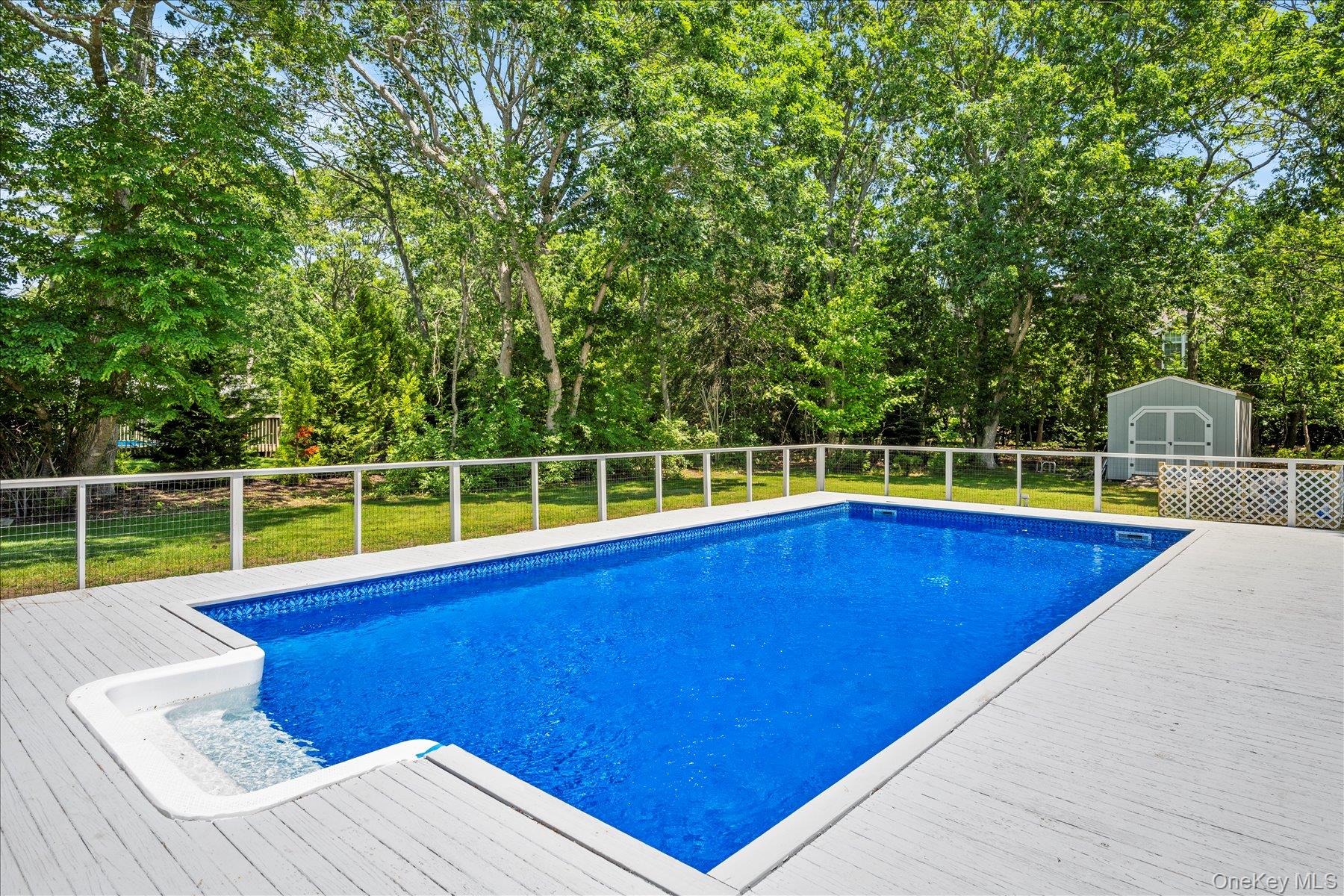 64 Old Depot Road Quogue, NY 11959 - Photo 14 of 14 a view of a backyard with swimming pool