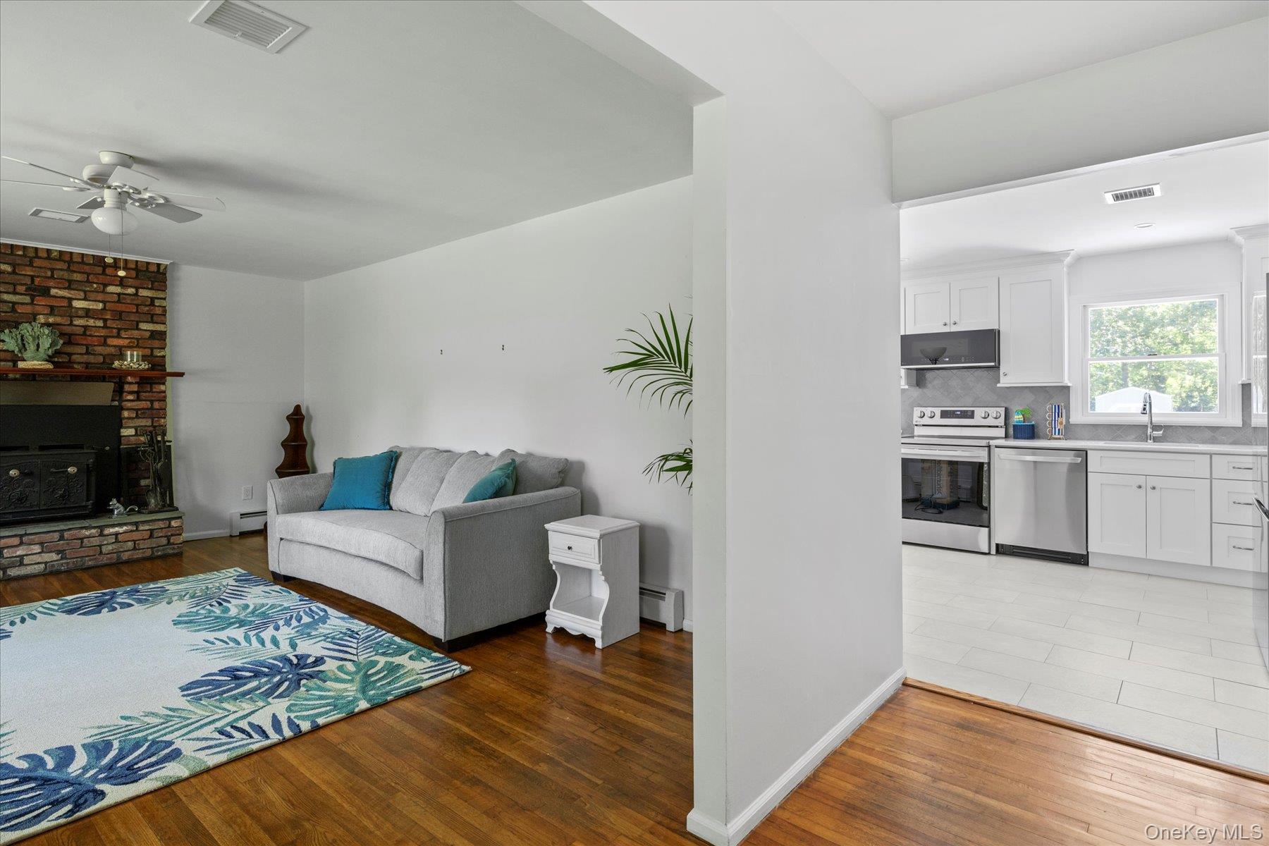 64 Old Depot Road Quogue, NY 11959 - Photo 4 of 14 a living room with furniture and a fireplace