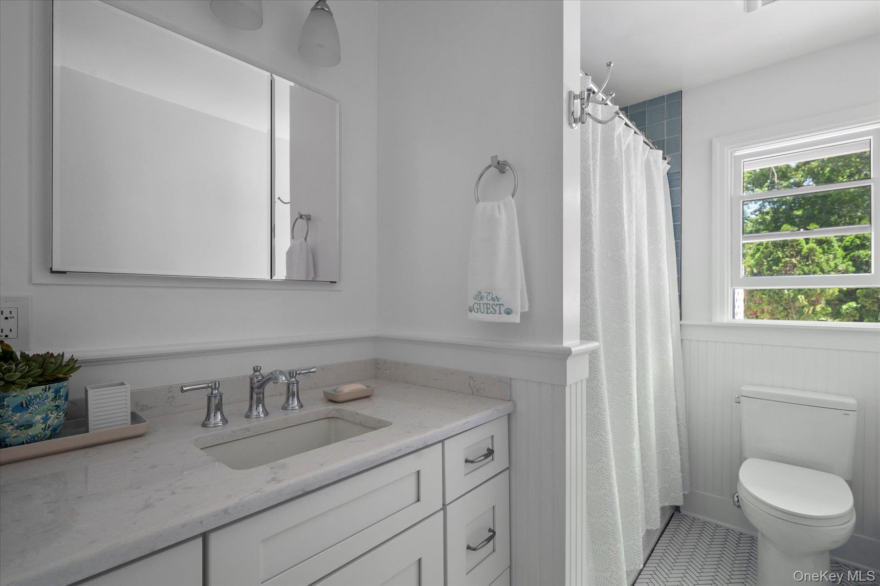 64 Old Depot Road Quogue, NY 11959 - Photo 5 of 14 a bathroom with a granite countertop sink vanity mirror and toilet