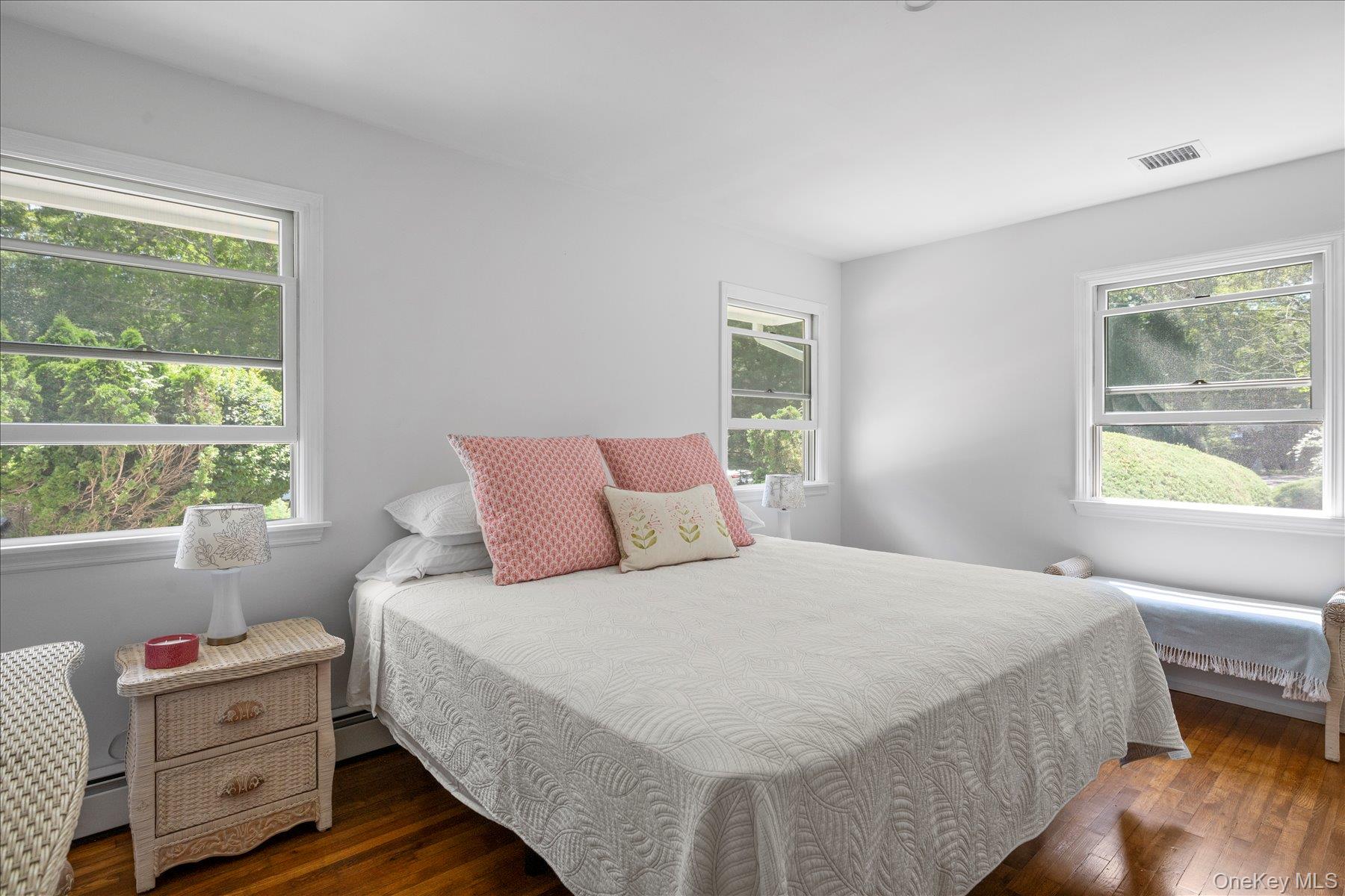 64 Old Depot Road Quogue, NY 11959 - Photo 6 of 14 a bedroom with a bed and wooden floor