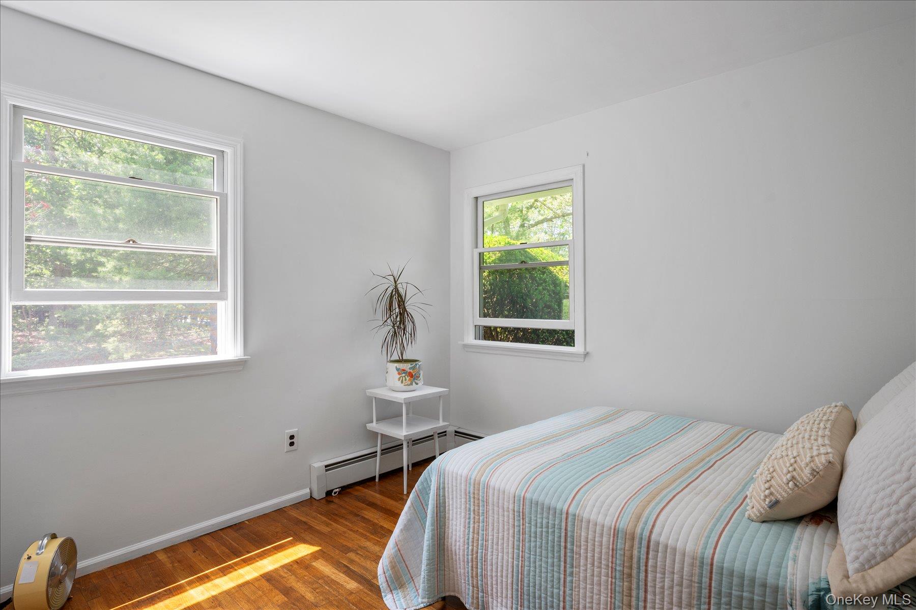 64 Old Depot Road Quogue, NY 11959 - Photo 7 of 14 a bedroom with a bed and a window