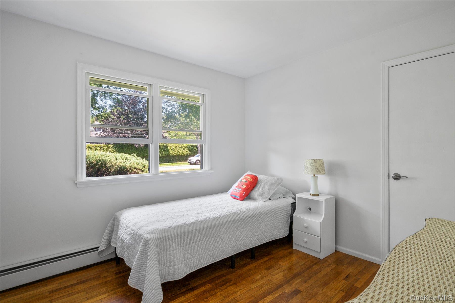 64 Old Depot Road Quogue, NY 11959 - Photo 9 of 14 a bedroom with a bed and wooden floor