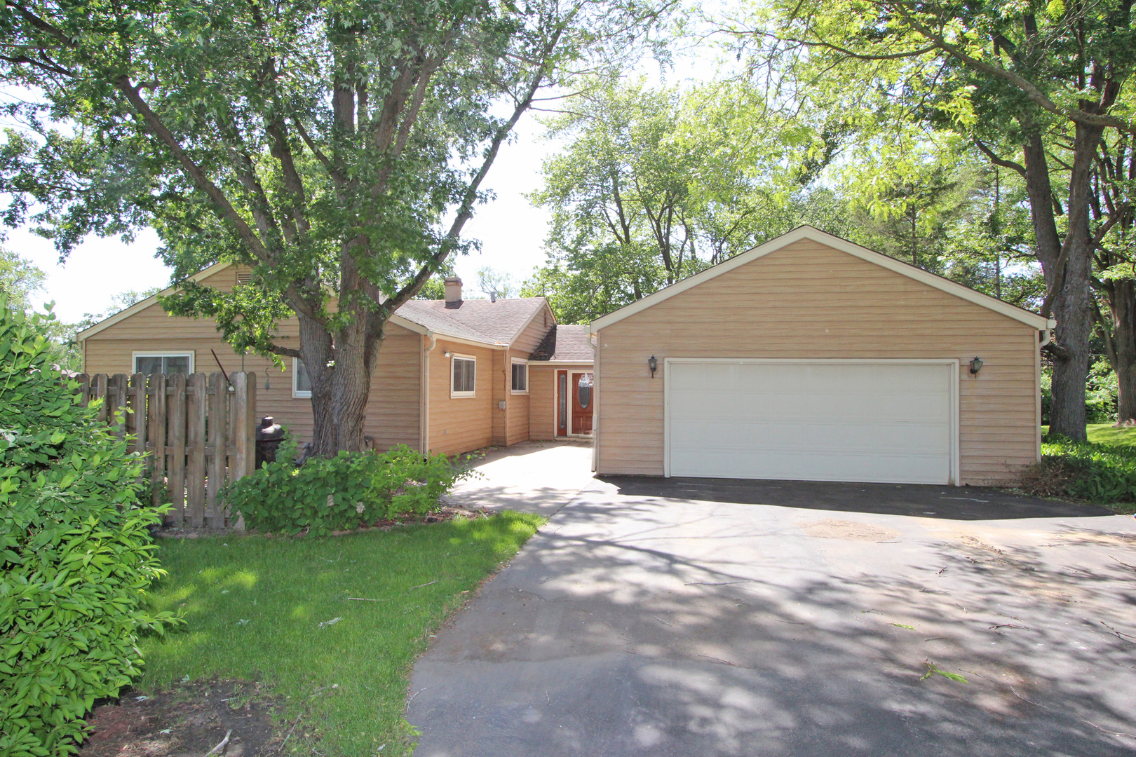 48 Golfview Road Lake Zurich, IL 60047 - Photo 1 of 1 a front view of a house with a yard and garage