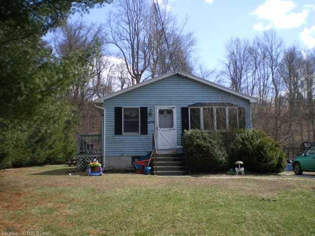 479 Valley Road Killingly, CT 06241 - Photo 1 of 1 a front view of house with yard and trees in the background
