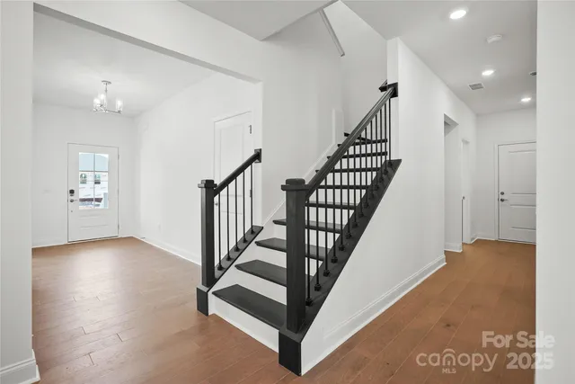 a view of entryway with wooden floor and stairs