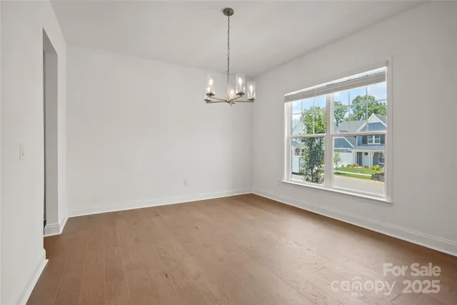 an empty room with windows and entrance